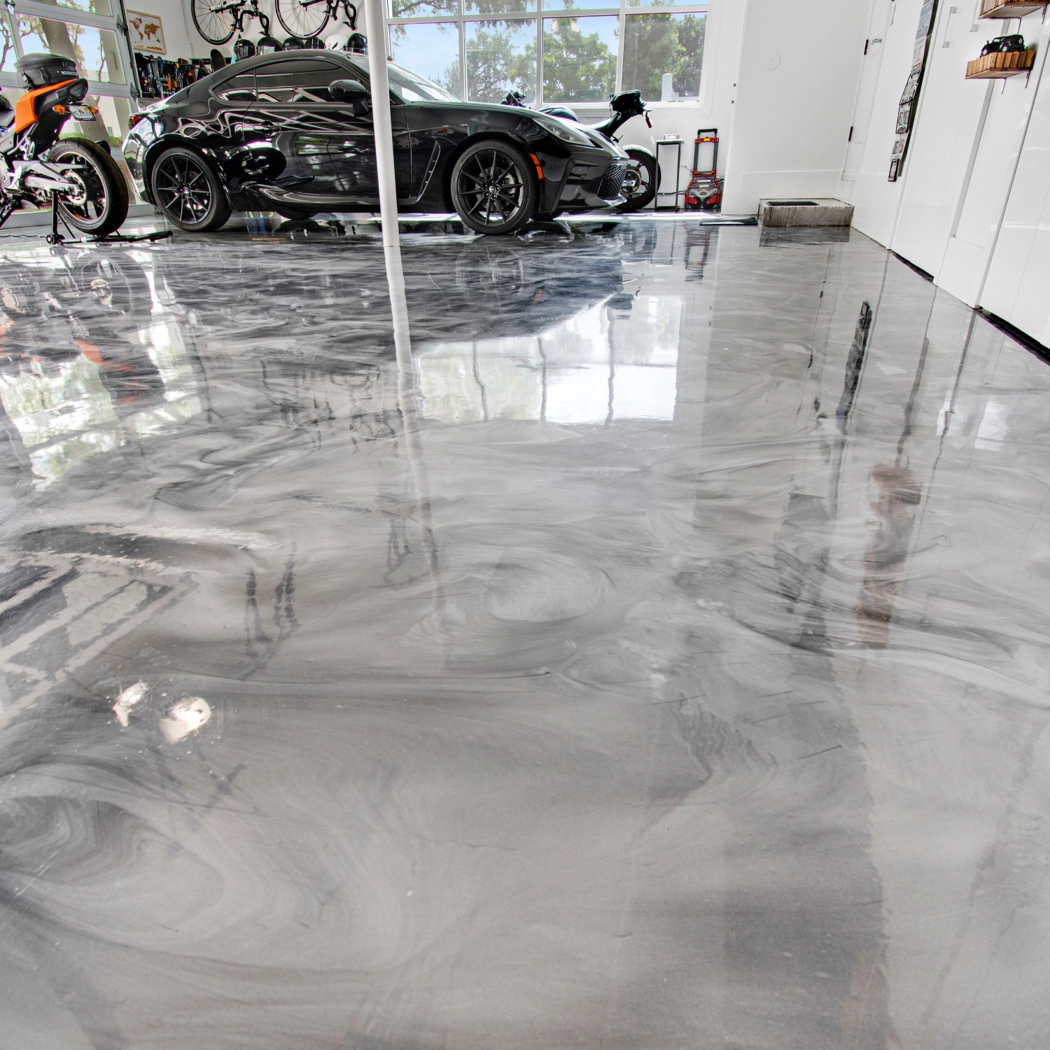 Grey epoxy garage floor with a smooth reflective finish
