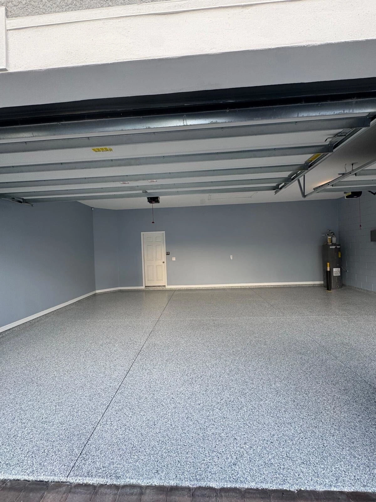 Empty garage interior with a light grey flake floor coating